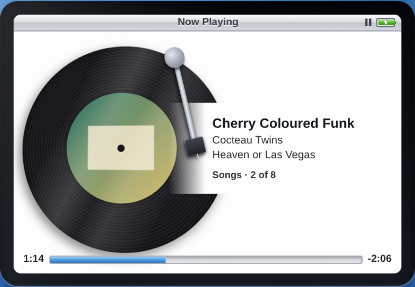 Now Playing showing a black vinyl record with the album art as its label, a tonearm resting on it, and the track details to the right.
