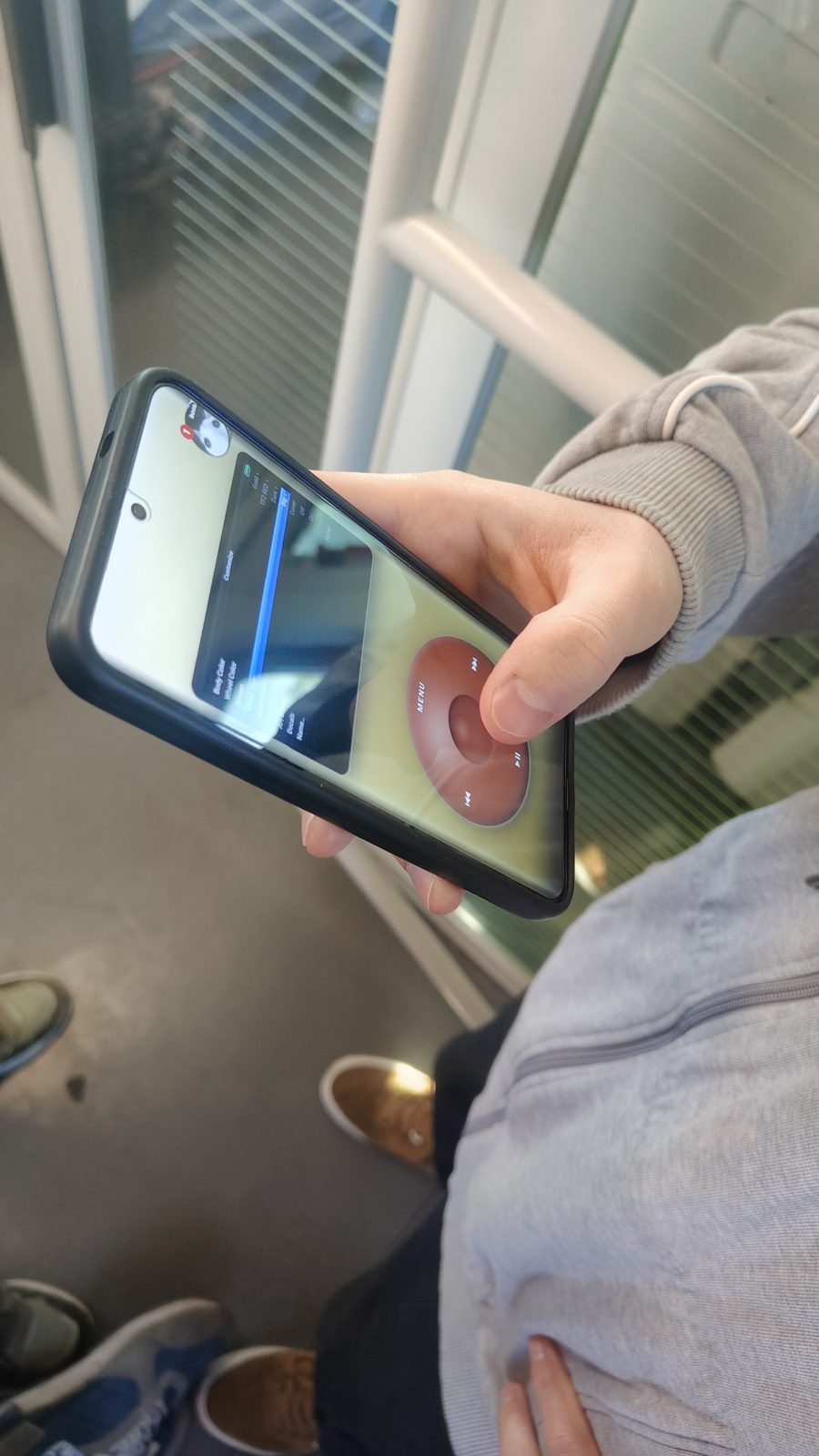 The player held sideways in landscape, the wheel filling half the screen.